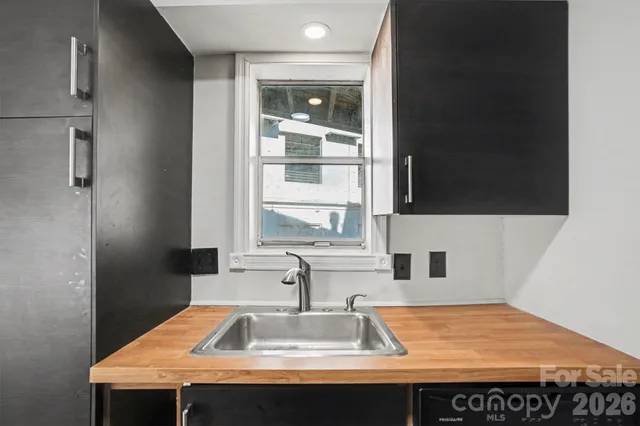 a view of empty room with a fireplace and wooden floor