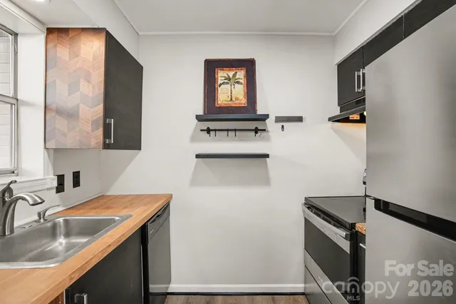 a kitchen with a sink and a refrigerator
