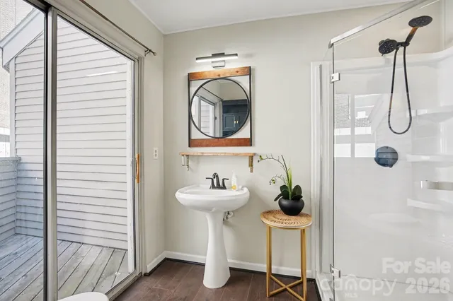 a bathroom with a sink a mirror a lamp and a window