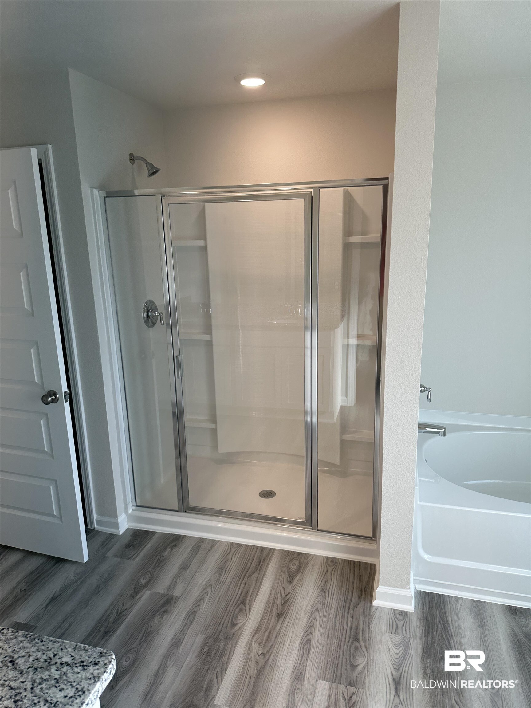 8850 Sea Star Circle Foley, AL 36535 - Photo 26 of 29 Bathroom featuring shower with separate bathtub and hardwood / wood-style flooring
