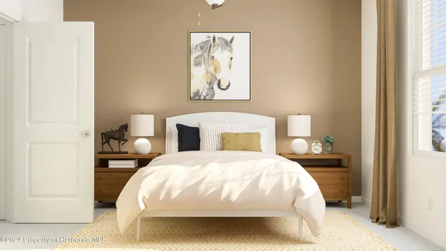 a bedroom with a bed and a painting on the wall