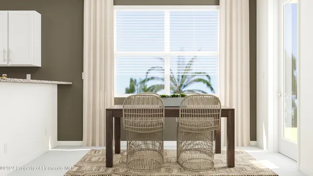 a dining room with furniture a potted plant and a window