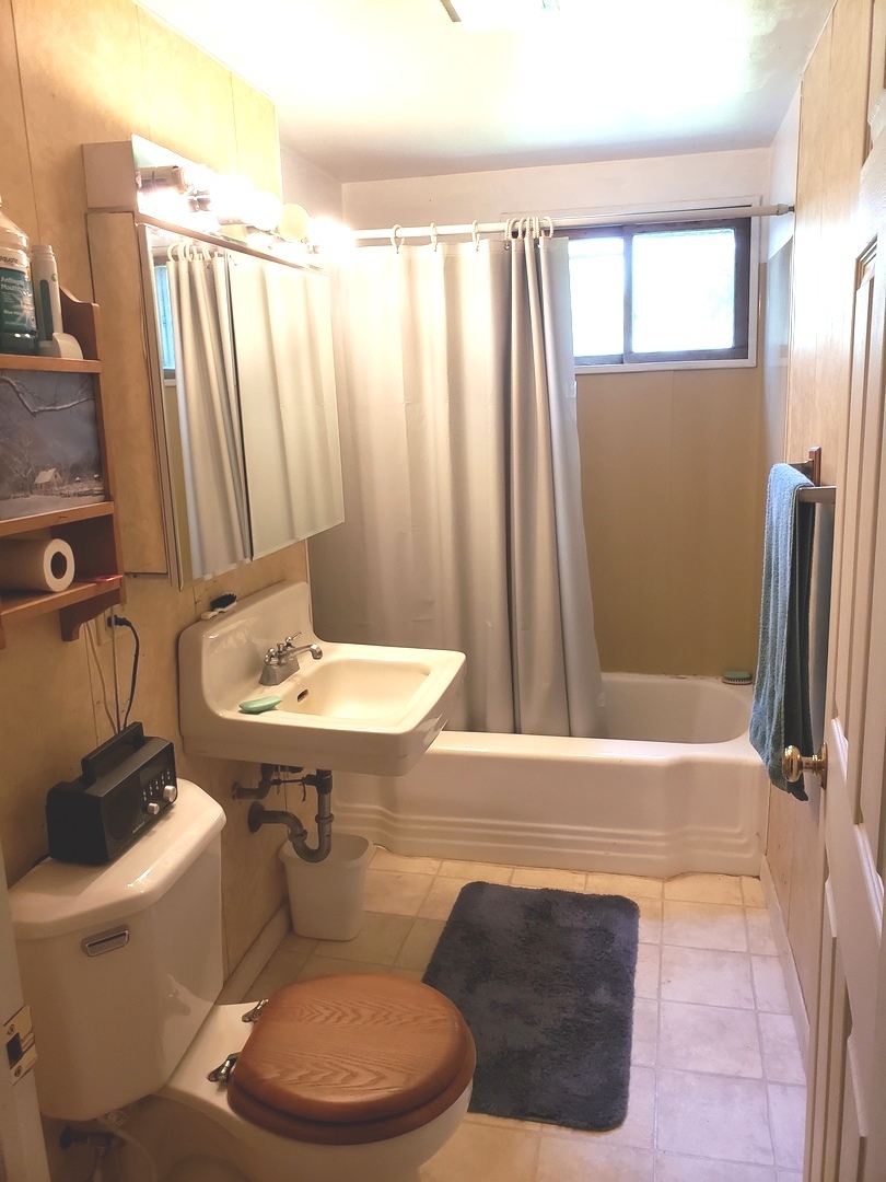 7120 A Tryon Grove Road Richmond, IL 60071 - Photo 16 of 23 a bathroom with a sink toilet and shower