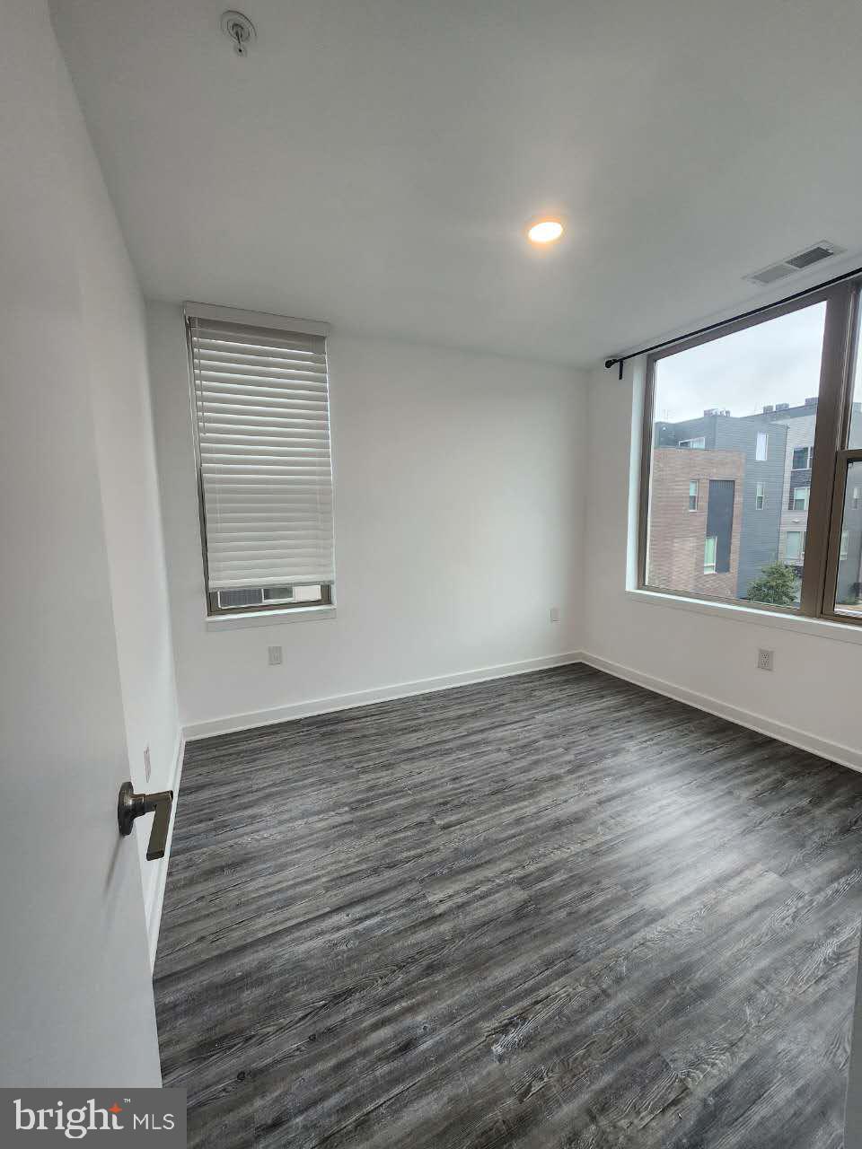 3129 Beachview Lane Philadelphia, PA 19125 - Photo 12 of 26 an empty room with wooden floor and windows