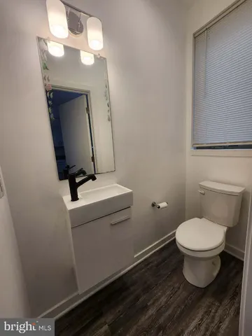 a bathroom with a toilet and a mirror