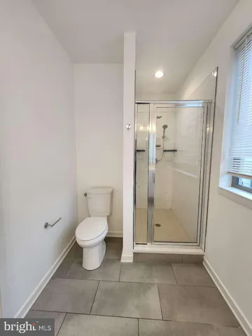 a bathroom with a toilet sink and shower