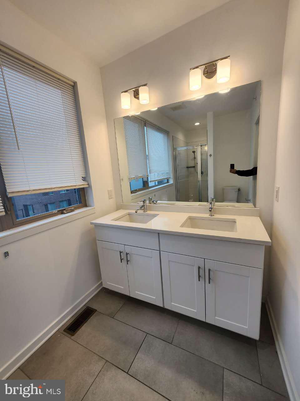 3129 Beachview Lane Philadelphia, PA 19125 - Photo 23 of 26 a bathroom with a sink and a mirror