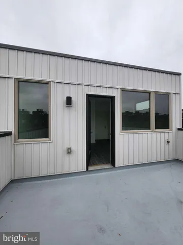 a view of a livingroom with an empty space and wooden floor