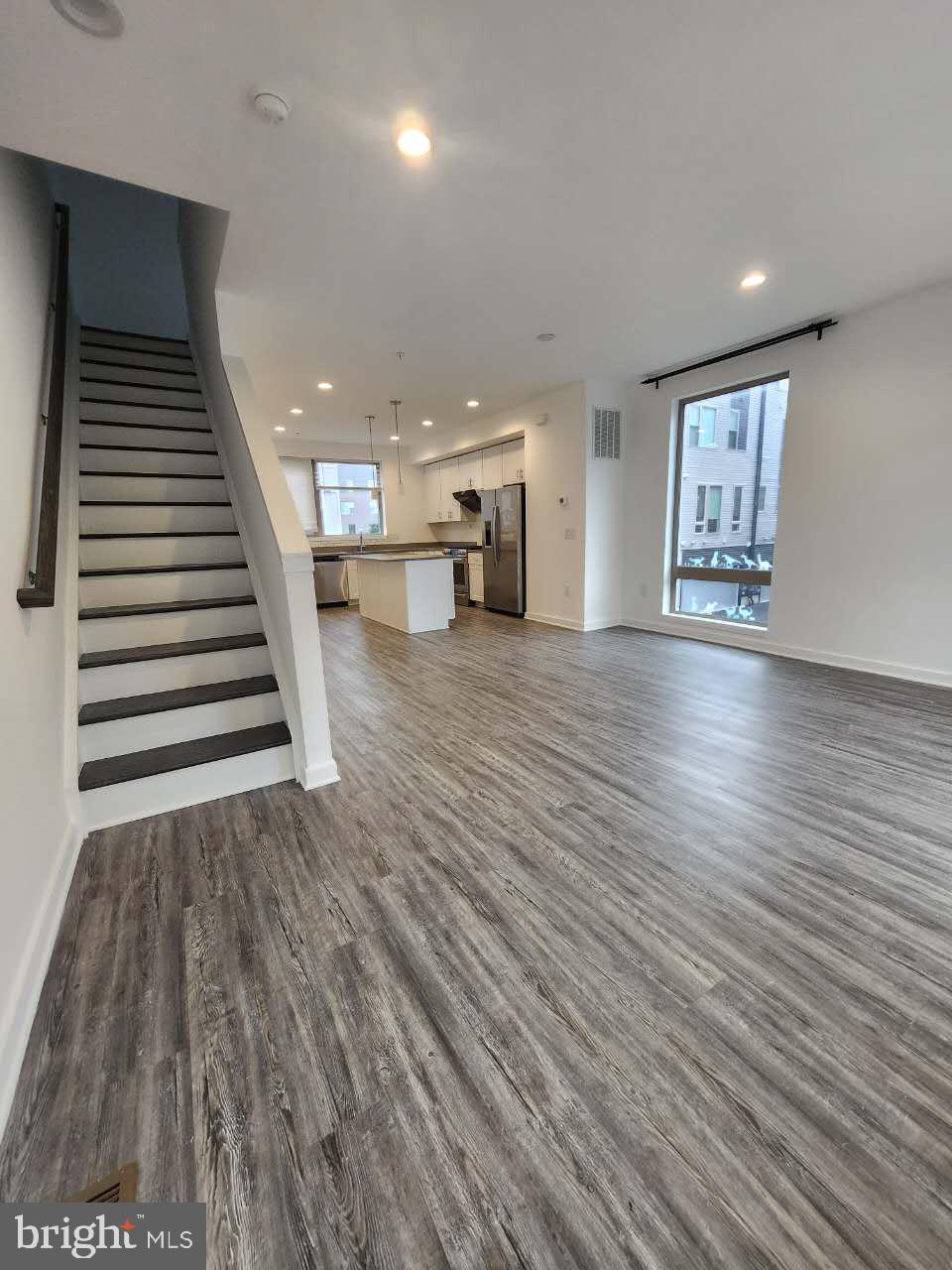 3129 Beachview Lane Philadelphia, PA 19125 - Photo 4 of 26 an empty room with wooden floors and stairs