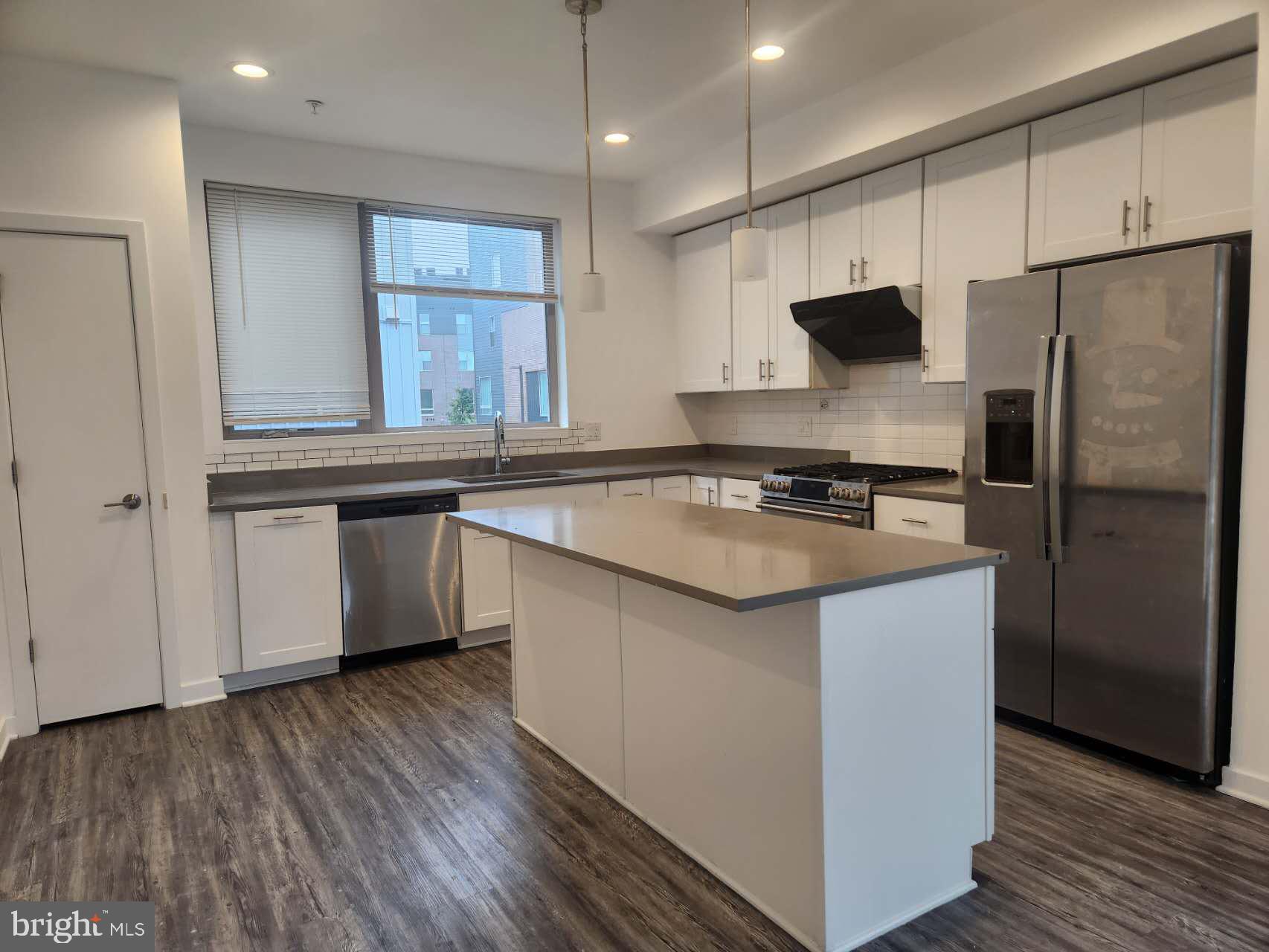 3129 Beachview Lane Philadelphia, PA 19125 - Photo 6 of 26 a kitchen with stainless steel appliances granite countertop a sink stove and refrigerator