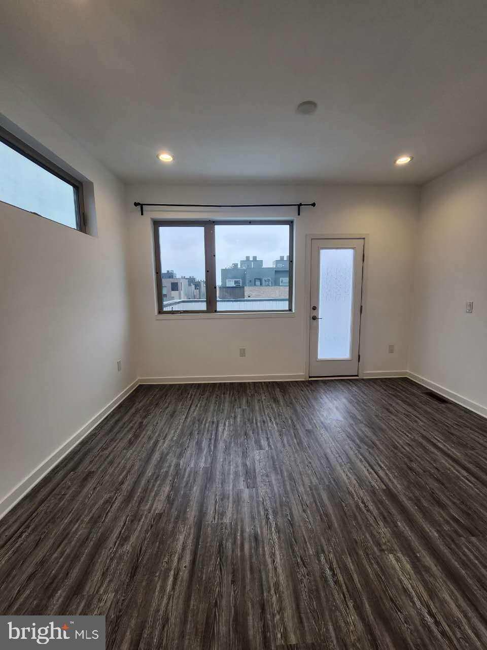 3129 Beachview Lane Philadelphia, PA 19125 - Photo 10 of 26 an empty room with wooden floor and windows