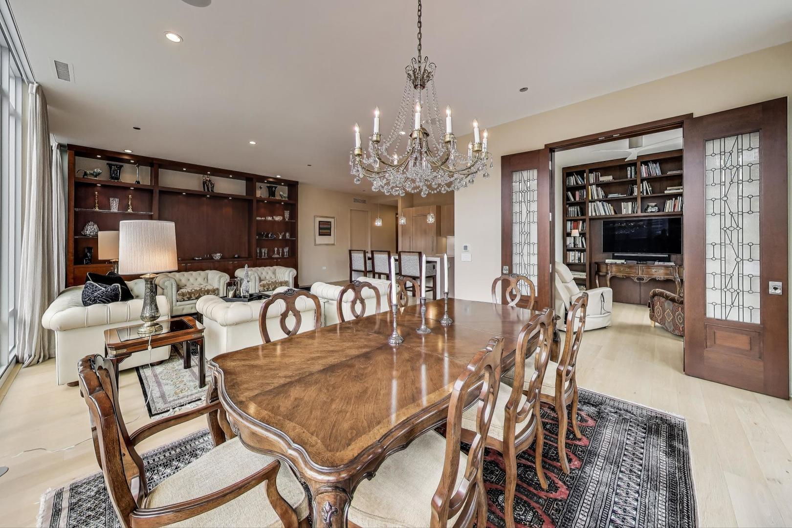 360 West Erie Street, Unit 7D Chicago, IL 60654 - Photo 15 of 39 a dining room with furniture a chandelier and wooden floor