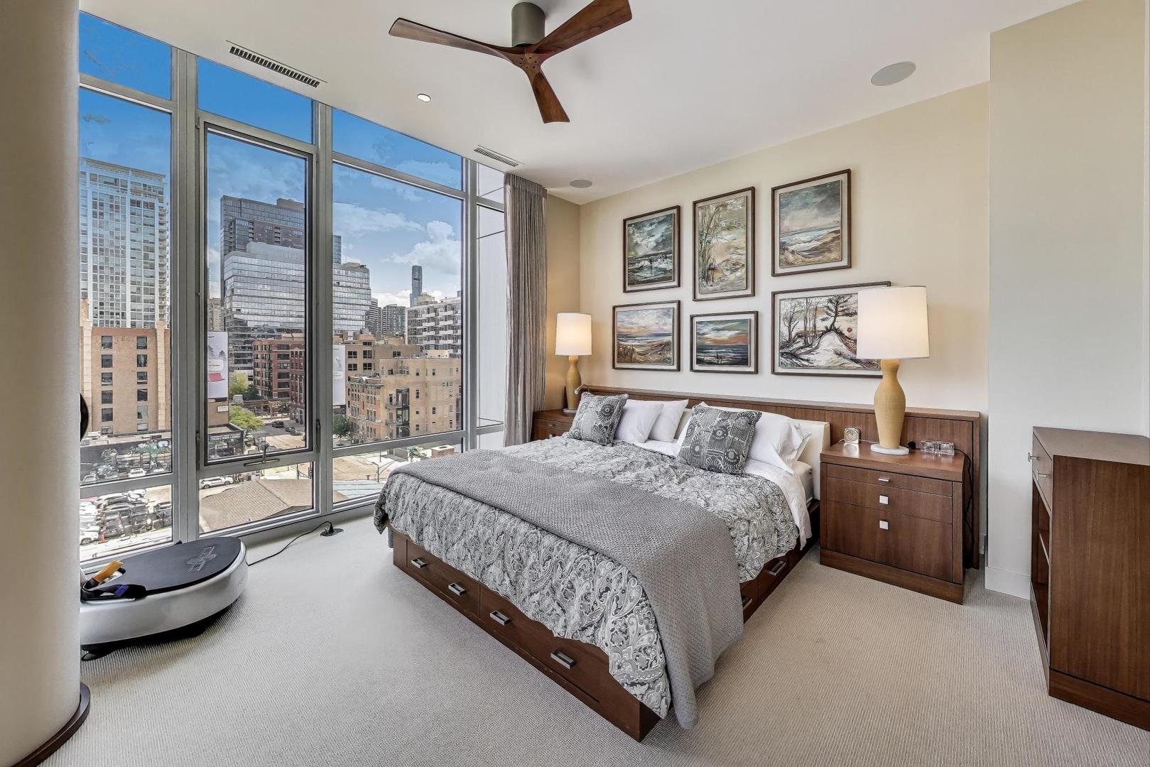360 West Erie Street, Unit 7D Chicago, IL 60654 - Photo 17 of 39 a bedroom with a large bed and a balcony view