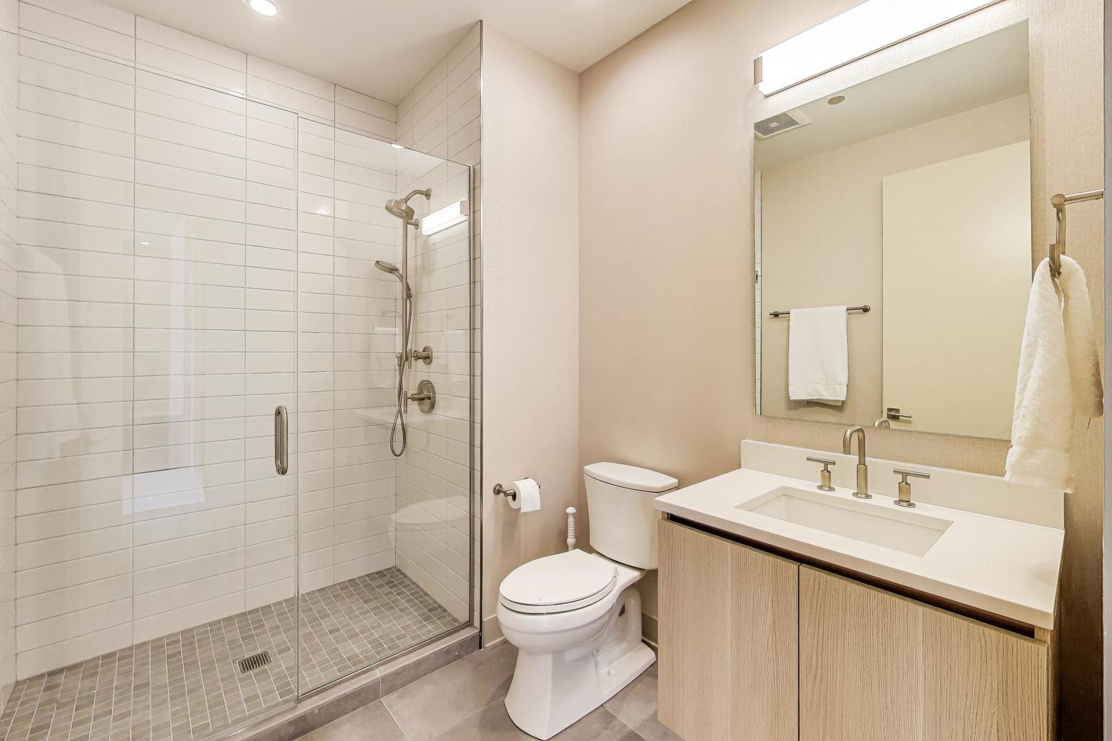 360 West Erie Street, Unit 7D Chicago, IL 60654 - Photo 22 of 39 a bathroom with a sink a toilet and shower