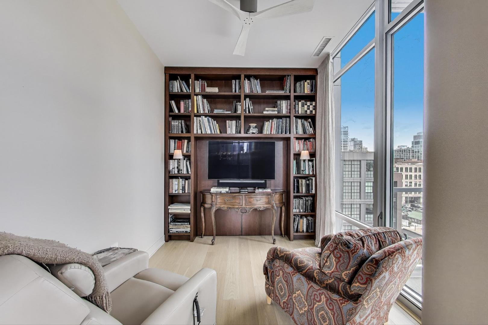 360 West Erie Street, Unit 7D Chicago, IL 60654 - Photo 25 of 39 a living room with furniture and a flat screen tv