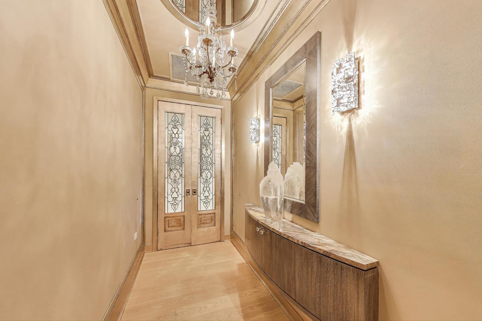360 West Erie Street, Unit 7D Chicago, IL 60654 - Photo 3 of 39 a view of a hallway with wooden floor and staircase