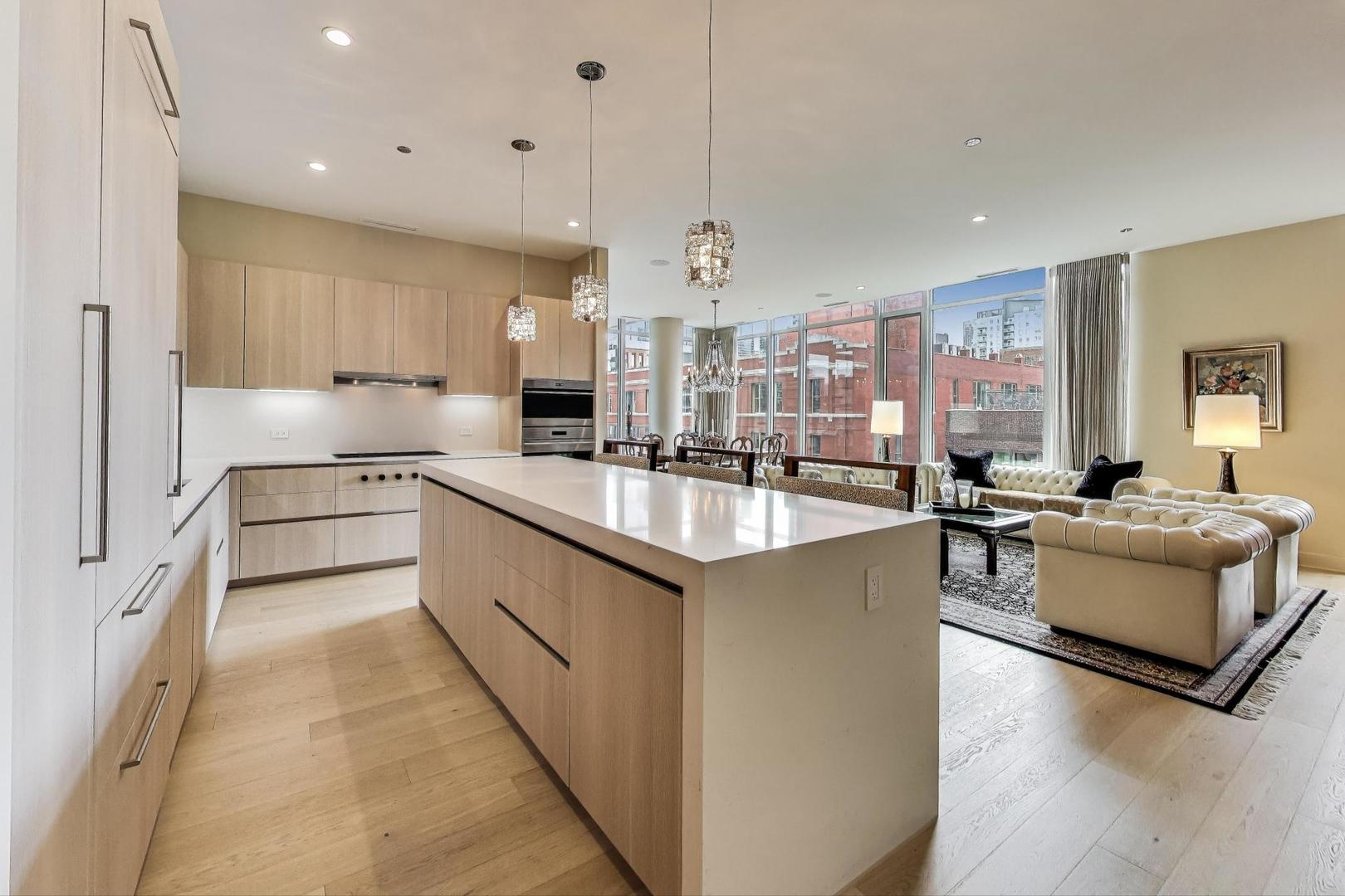 360 West Erie Street, Unit 7D Chicago, IL 60654 - Photo 8 of 39 a kitchen with granite countertop a sink stove and cabinets