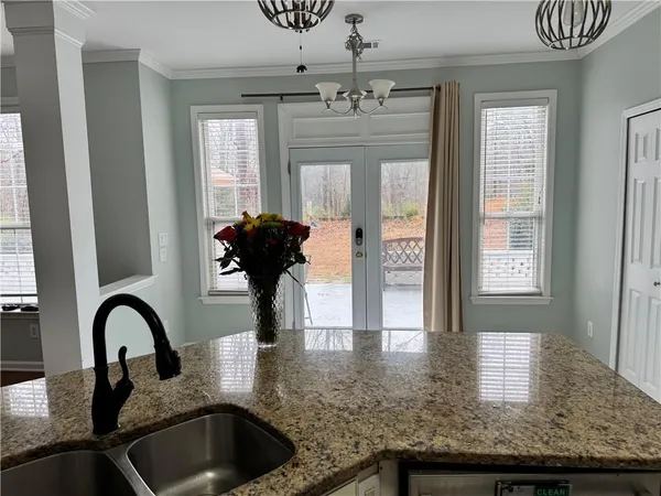 a kitchen with stainless steel appliances granite countertop a refrigerator a stove and a sink