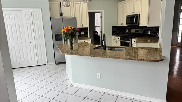 a kitchen with stainless steel appliances granite countertop a refrigerator and a stove