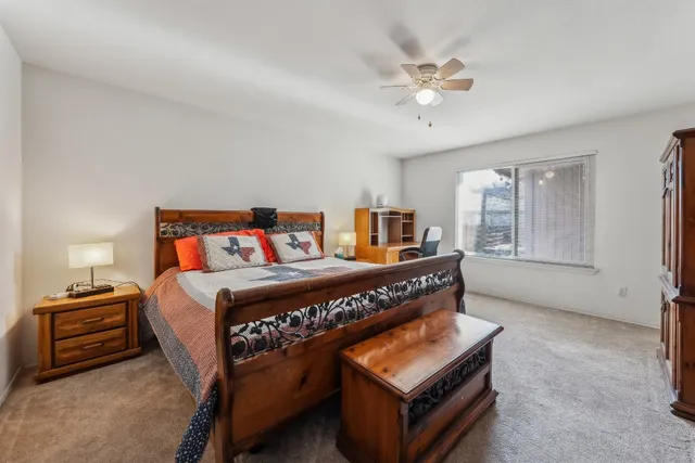 a bedroom with a bed and a chandelier