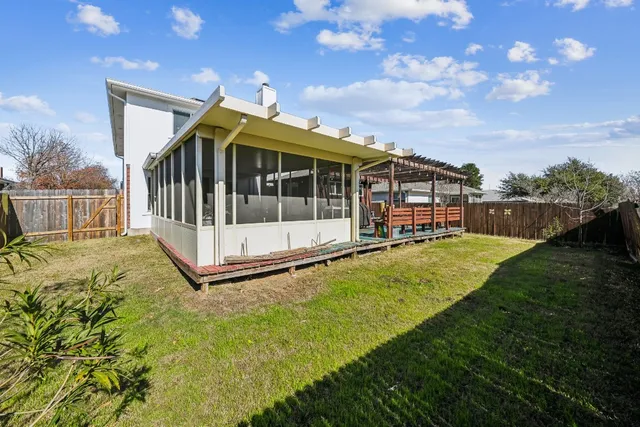 a view of a house with swimming pool and sitting area
