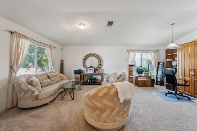 a living room with furniture a large window and a fireplace