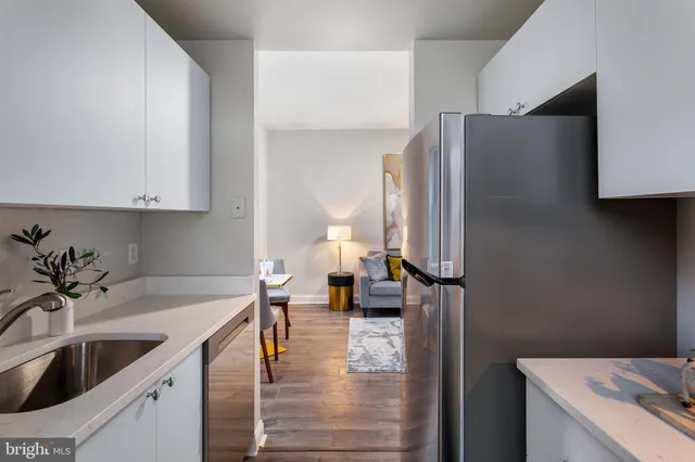 a kitchen with a sink and a refrigerator