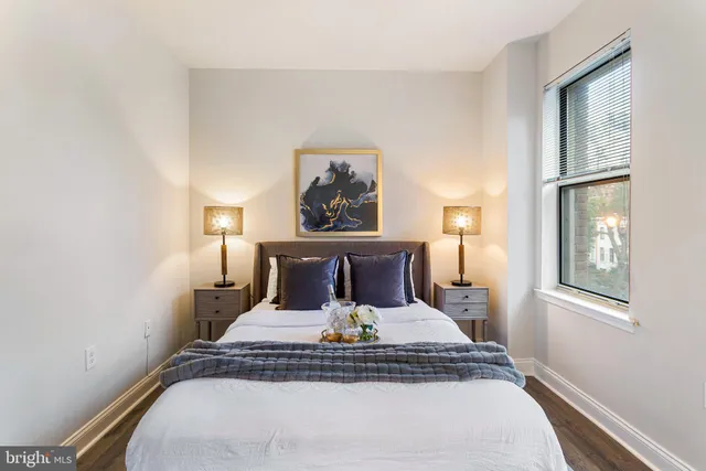 a bed sitting in a bedroom next to a window