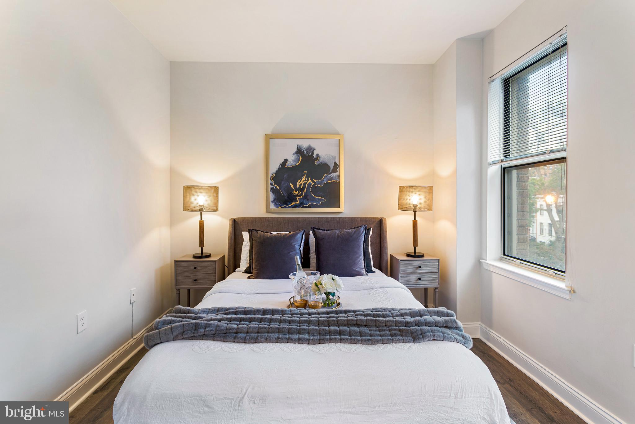 1621 T Street Northwest, Unit 305 Washington, DC 20009 - Photo 17 of 33 a bed sitting in a bedroom next to a window