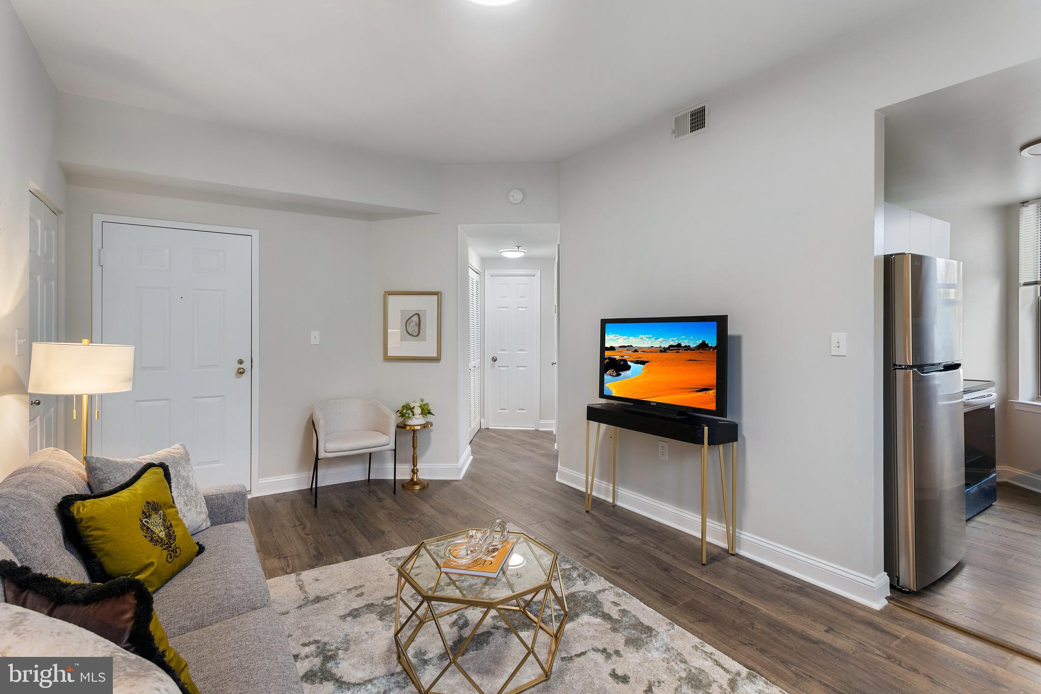 1621 T Street Northwest, Unit 305 Washington, DC 20009 - Photo 5 of 33 a living room with furniture and a flat screen tv