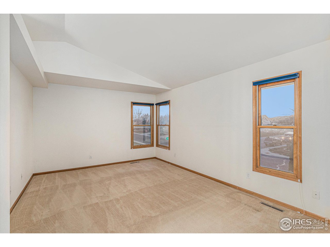 3000 Antelope Road Fort Collins, CO 80525 - Photo 13 of 31 Serene Primary Retreat with vaulted ceilings, wraparound windows (mountain views), and large walk-in closet.