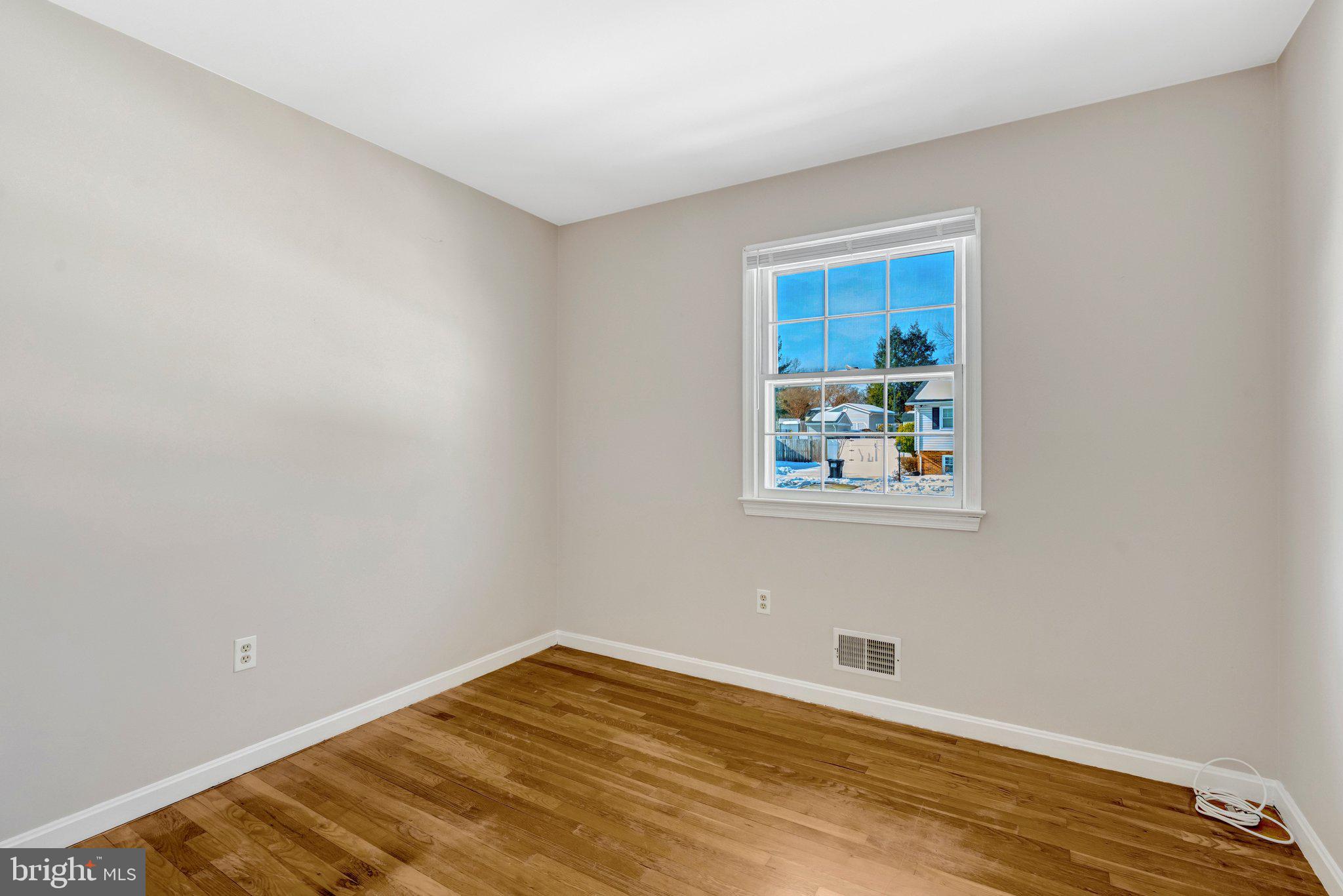 7413 Forrester Lane Manassas, VA 20109 - Photo 17 of 45 a view of an empty room with wooden floor and a window