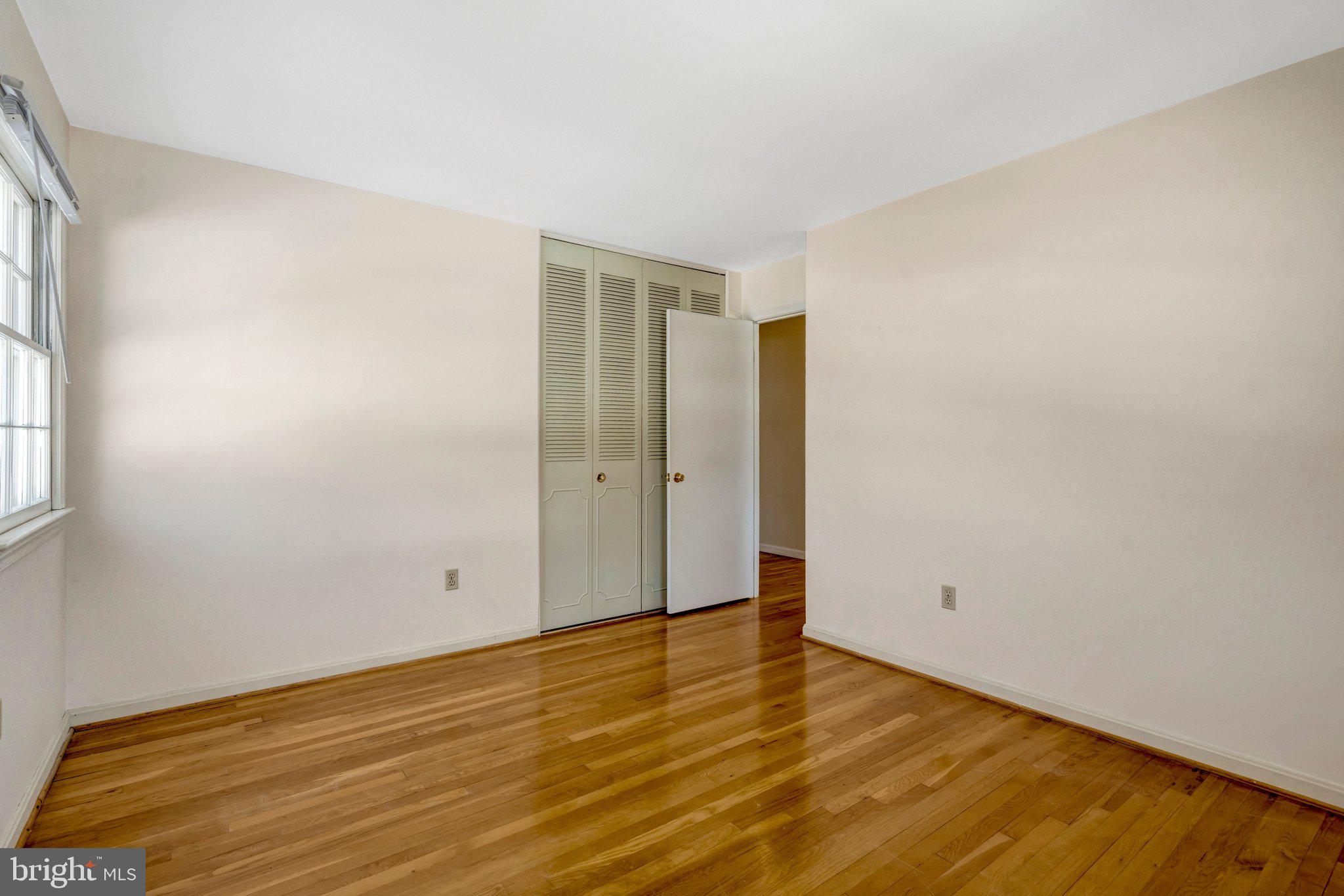 7413 Forrester Lane Manassas, VA 20109 - Photo 18 of 45 a view of an empty room with wooden floor and a window