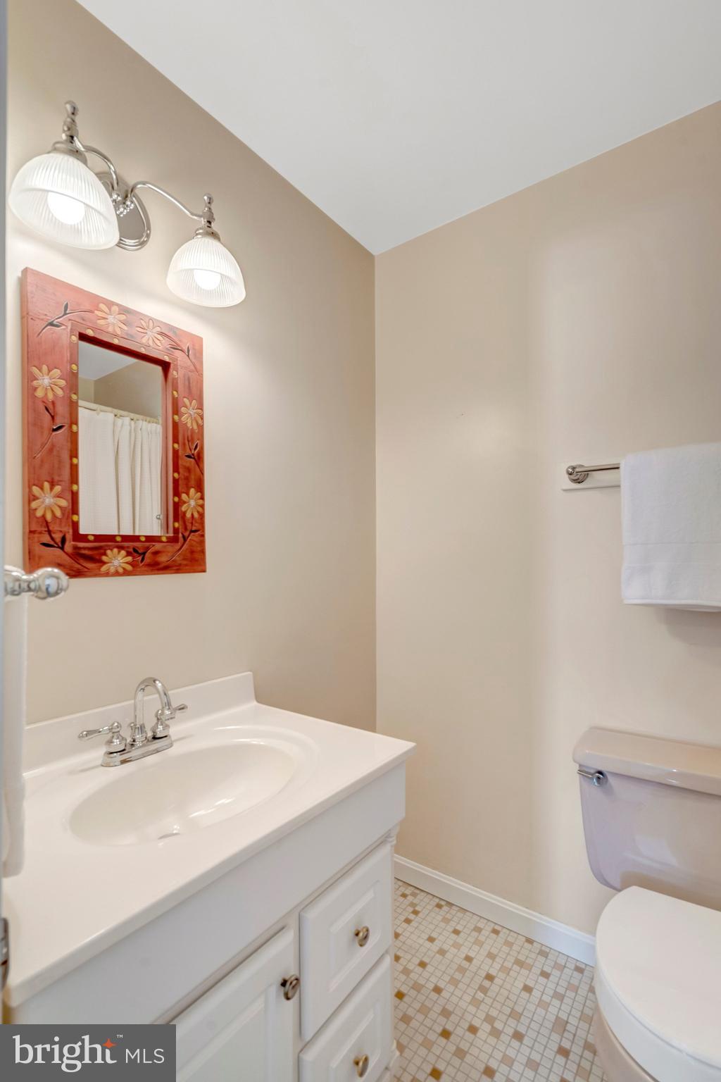 7413 Forrester Lane Manassas, VA 20109 - Photo 20 of 45 a bathroom with a sink a toilet and mirror