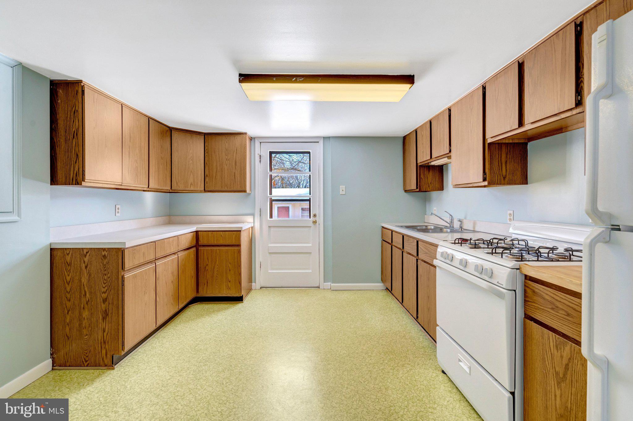 7413 Forrester Lane Manassas, VA 20109 - Photo 26 of 45 a kitchen with a stove top oven sink and cabinets