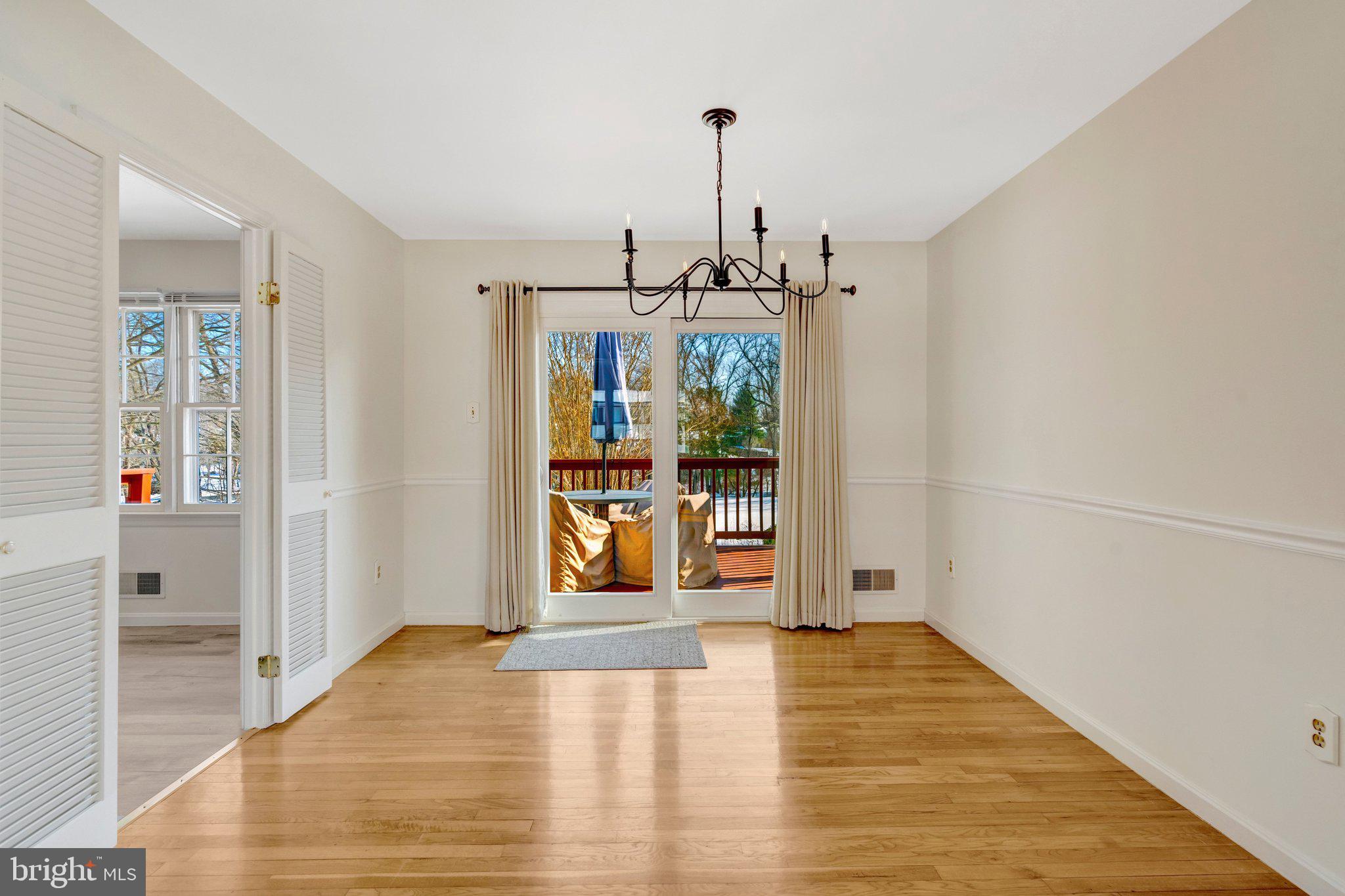 7413 Forrester Lane Manassas, VA 20109 - Photo 6 of 45 a view of an empty room with window and wooden floor