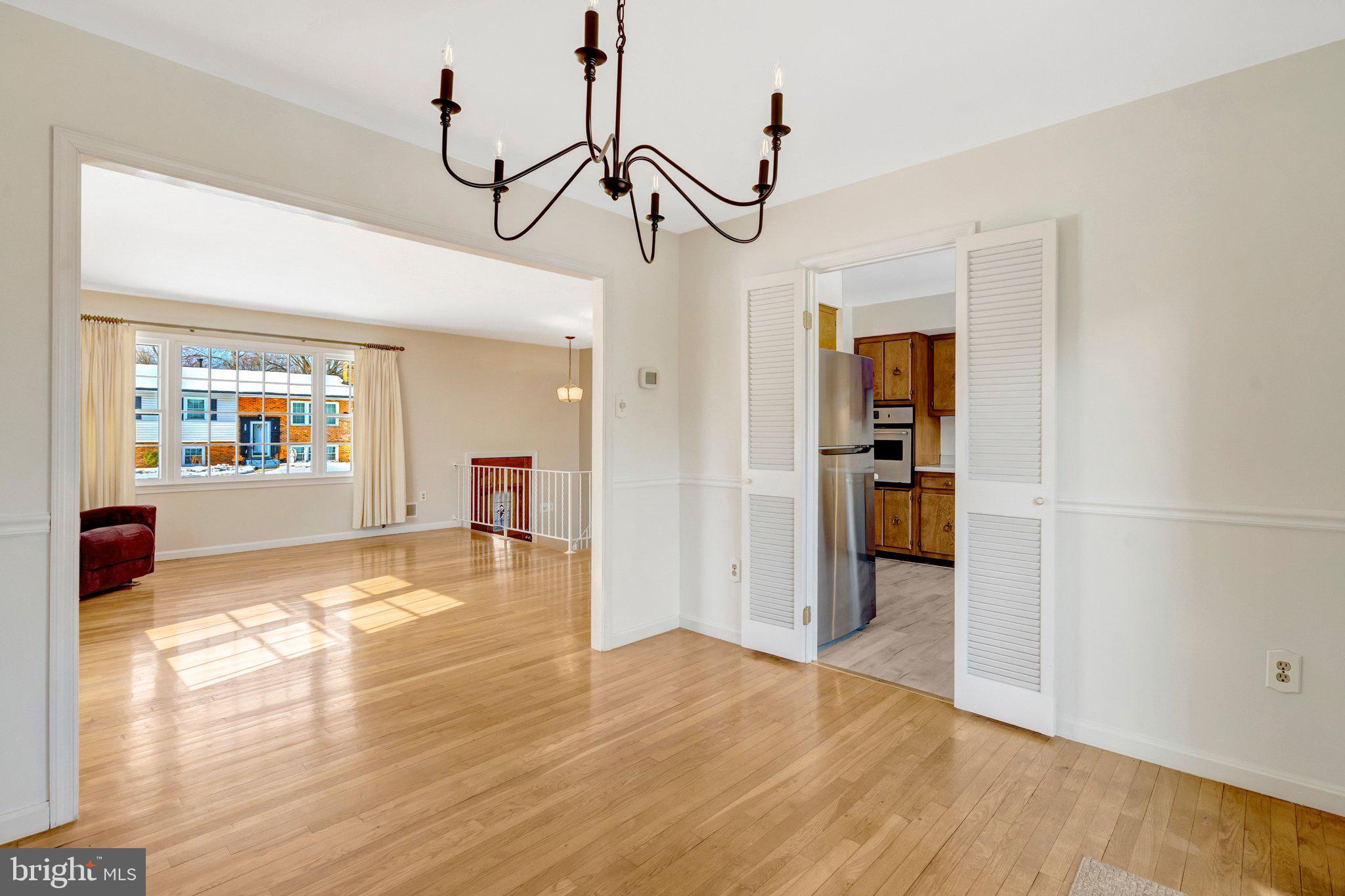 7413 Forrester Lane Manassas, VA 20109 - Photo 7 of 45 a view of a living room and a kitchen with a sink