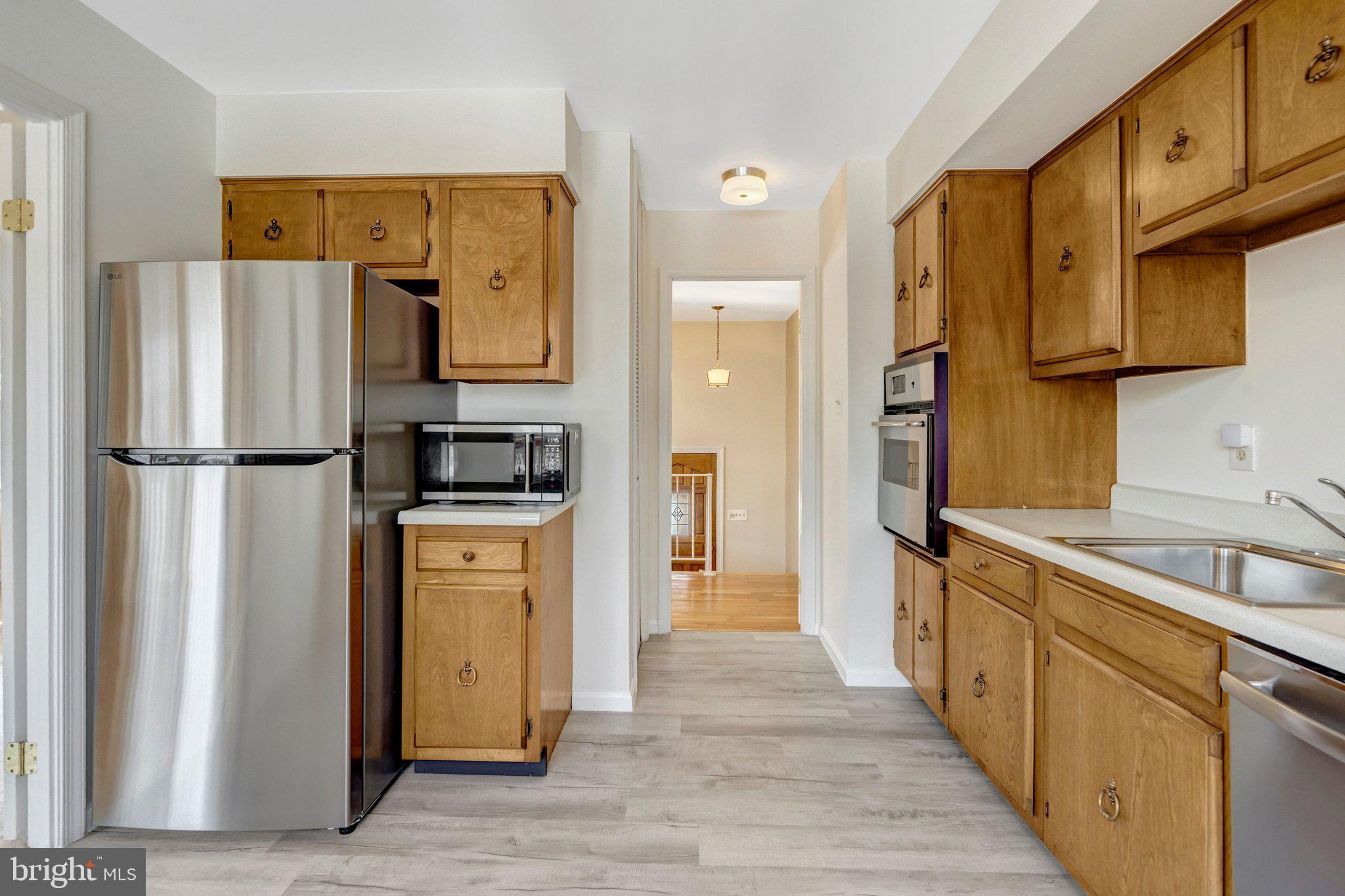 7413 Forrester Lane Manassas, VA 20109 - Photo 10 of 45 a kitchen with stainless steel appliances granite countertop a refrigerator and a sink