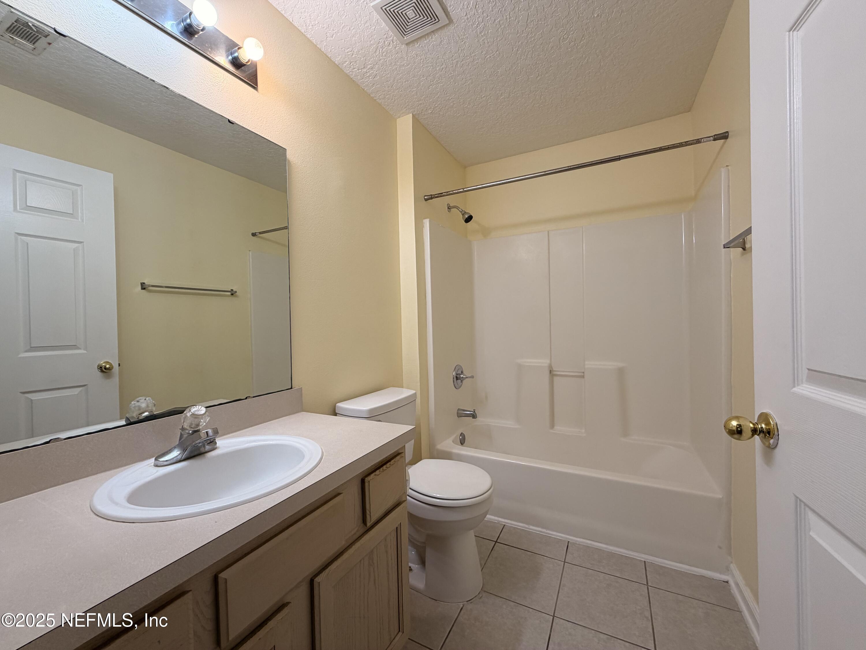 7920 Merrill Road, Unit 810 Jacksonville, FL 32277 - Photo 11 of 14 a bathroom with a sink a toilet and shower