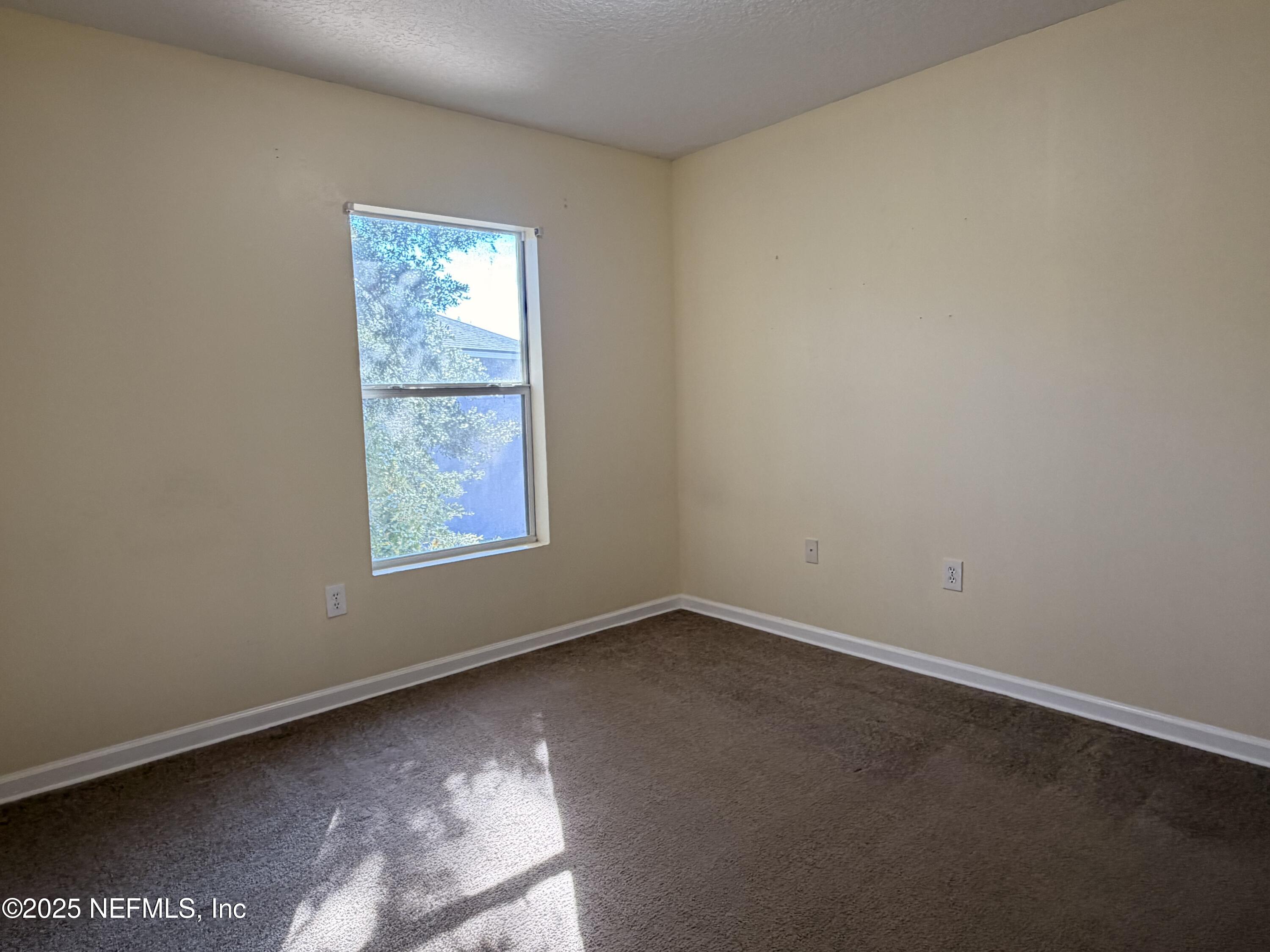 7920 Merrill Road, Unit 810 Jacksonville, FL 32277 - Photo 14 of 14 an empty room with a window