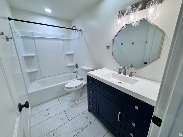 4729 Middleboro Road Herriman, UT 84096 - Photo 13 of 19 Bathroom featuring a dark blue vanity with silver hardware, an integrated white sink, and a coordinating octagonal mirror