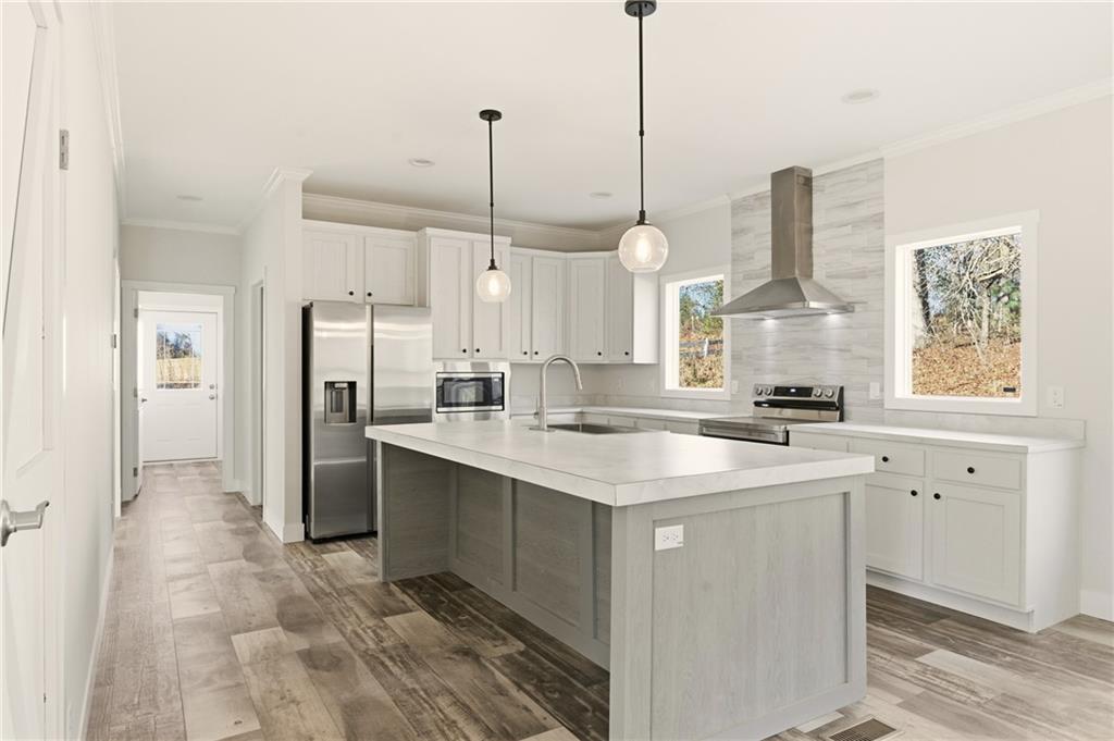 211 Loving Road Morganton, GA 30560 - Photo 18 of 34 a kitchen with stainless steel appliances granite countertop a sink a counter space and a window