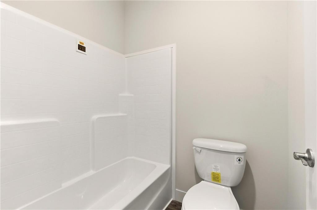 211 Loving Road Morganton, GA 30560 - Photo 26 of 34 a white toilet sitting next to a bath tub