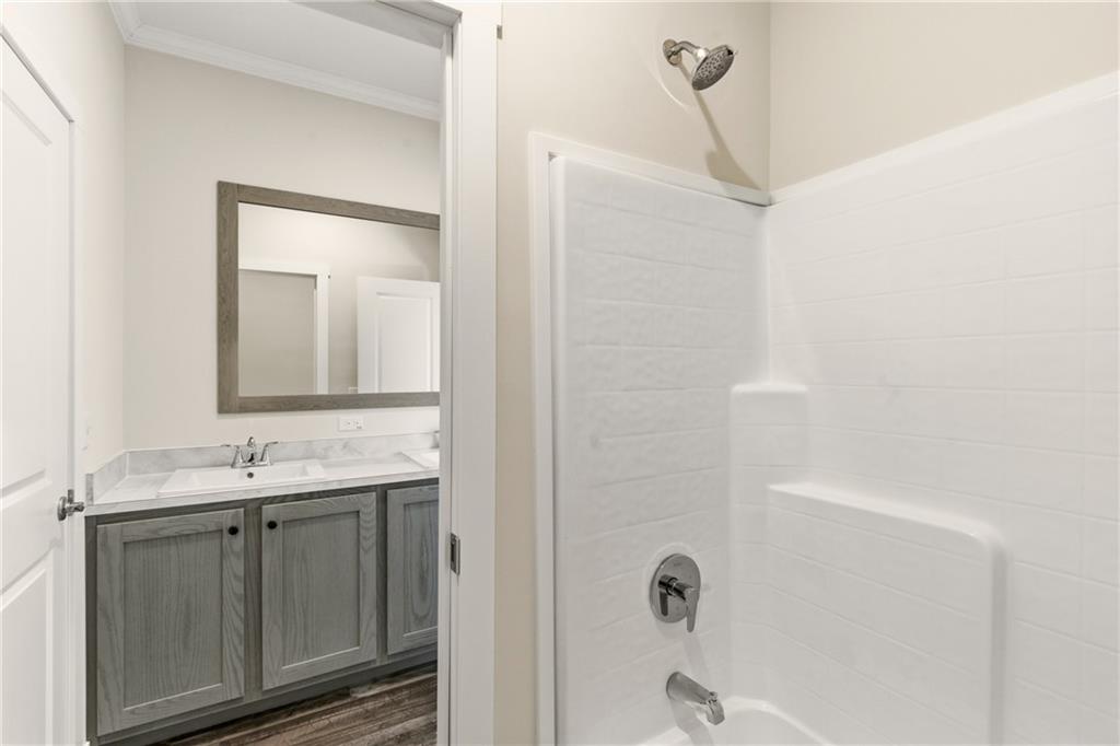 211 Loving Road Morganton, GA 30560 - Photo 27 of 34 a bathroom with a granite countertop sink a mirror and a shower