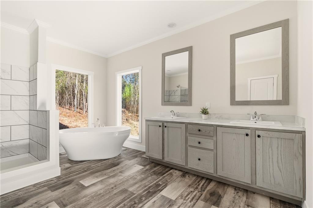 211 Loving Road Morganton, GA 30560 - Photo 10 of 34 a spacious bathroom with double vanity a mirror a bathtub and a shower