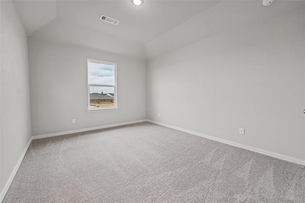 1205 Colca Drive Springtown, TX 76082 - Photo 27 of 37 Neutral-toned carpeting, light gray wall paint, and a single window with white trim