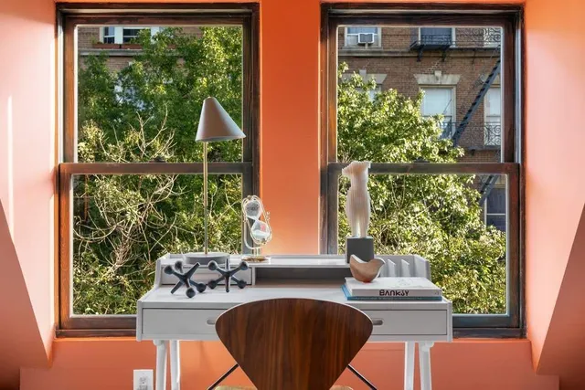 a view of a window and a table chair in the balcony