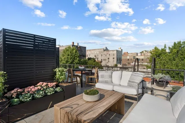 a view of a patio with furniture and a potted plant