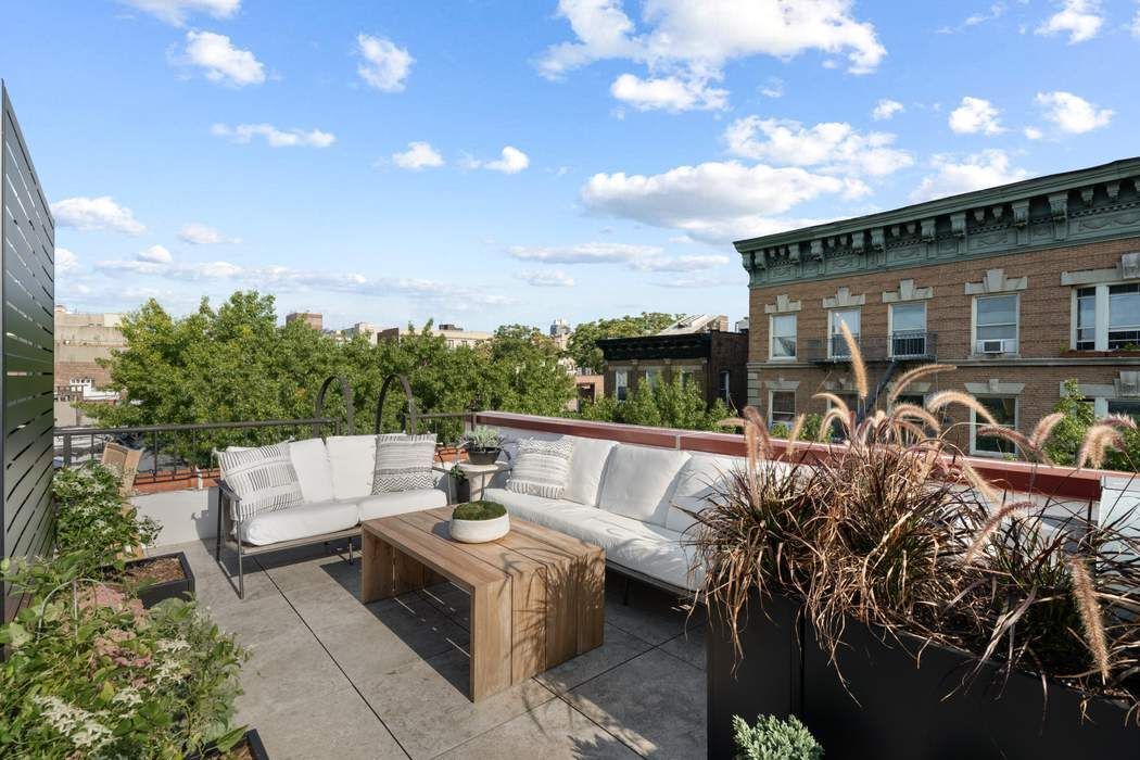 721 St Nicholas Avenue, Unit PH4 Manhattan, NY 10031 - Photo 2 of 17 a view of a patio with couches and potted plants