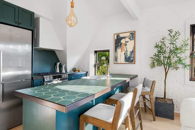 a view of a kitchen area kitchen island furniture and a refrigerator